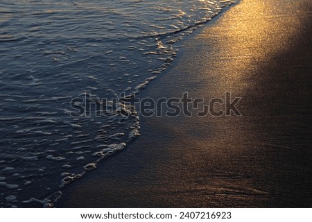 Sunset over peaceful beach. Abstract texture on the beach during sunrise. Sand on sunset with sun reflection. Sunset in  beach