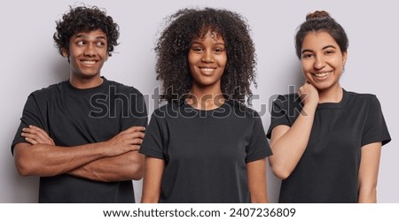 Collage image of cheerful ethnic diverse people express positive emotions smile gladfully dressed in casual basic black t shirts isolated over white background. Smiling faces. Three people standing Royalty-Free Stock Photo #2407236809