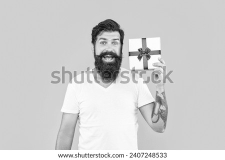 happy man with present box isolated on yellow. man with present box in studio.