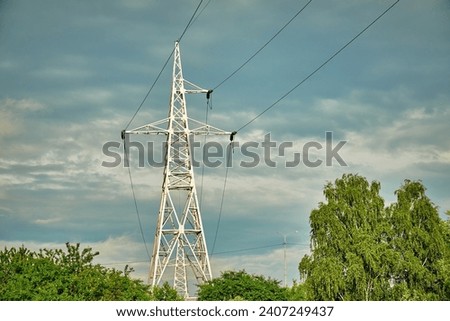 High voltage pylon against a cloudy sky.
