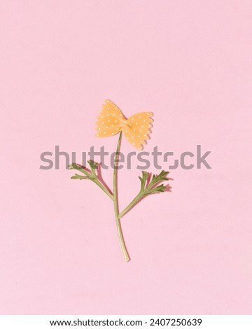 Pasta in the shape of a bow, creative spring flower layout Royalty-Free Stock Photo #2407250639