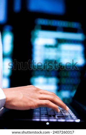 Engineer ensuring proper functioning of VPN servers with top security standards used to protect sensitive data, close up. Admin using laptop to check equipment providing internet connections for users