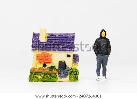 A picture of house miniature with miniature men insight. Men and property.