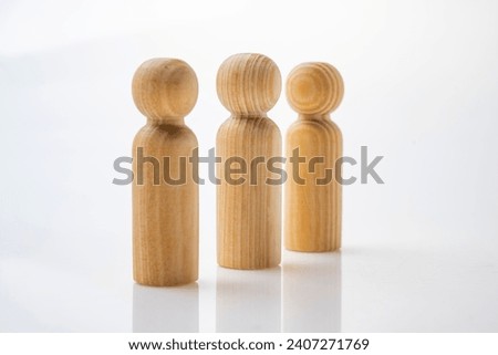 Closeup view row of wooden figure isolated over white background