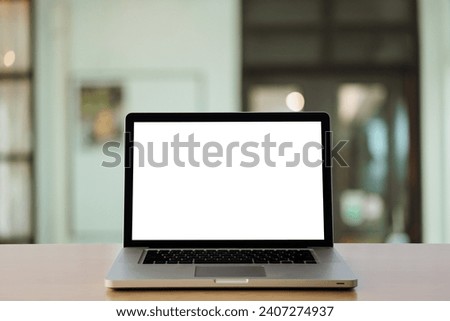 Mockup desktop Laptop on desk in living room background. workspace with blank 