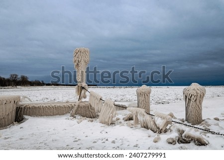Strange Ice Formations on Pier in Lake Erie, Canada, Day after Winter Storm, stormy sky, winter wonderland  Royalty-Free Stock Photo #2407279991