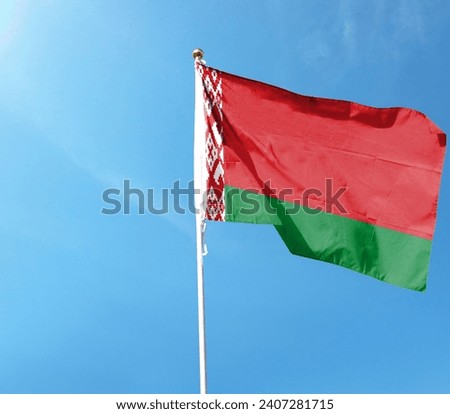 Belarus flag on cloudy sky. flying in the sky Royalty-Free Stock Photo #2407281715