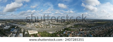 Panorama view of Bangkok city skyline, transportation with cars on Expressway, Road and Roundabout, multilevel junction highway-Top view. Important infrastructure, cloudscape, cityscape, building.