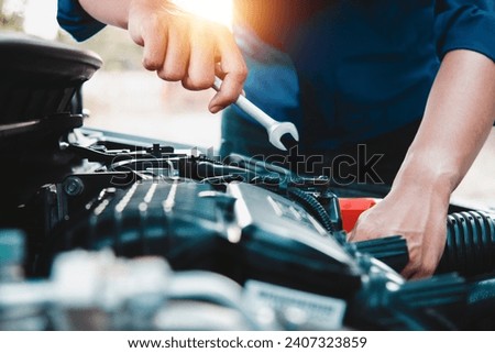 Mechanic open vehicle hood checking up auto mobile, fixing a car at home,Repair and service Royalty-Free Stock Photo #2407323859