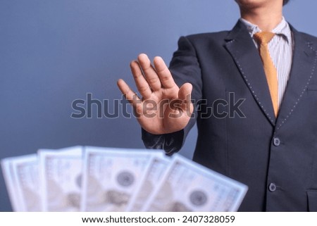 Businessman refusing money offered by a man. Anti bribery and corruption concepts Royalty-Free Stock Photo #2407328059