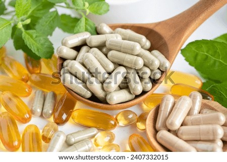 Alternative medicine herbal organic capsule with vitamin E omega 3 fish oil, mineral, drug with herbs leaf natural supplements for healthy good life. Royalty-Free Stock Photo #2407332015