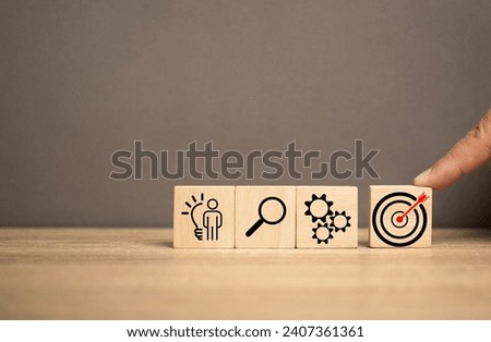 man push a wooden cube has the red dart in the middle. Business, Advertising, marketing and targeting. Clear and specific goals.Strategy plan for success target. Marketing plan idea strategy.