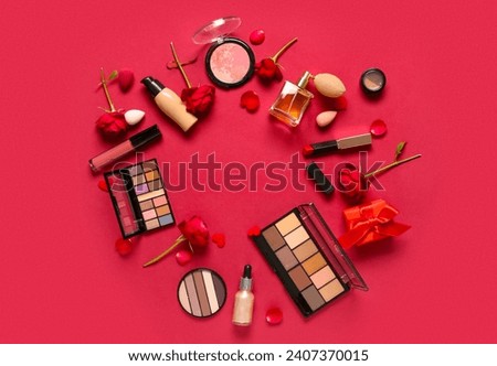 Frame made of cosmetic products with roses and hearts on red background. Valentine's day celebration