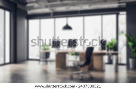 Blurred Modern industrial office interior space background. Blur interior of modern open workplace with big windows full furniture and decoration plants inside with wooden floor .