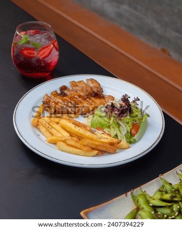 An enticing image of beef steak served with delectable french fries, creating an appetizing ambiance. Sharp details, rich color contrasts make this picture perfect to entice and awaken the taste buds.