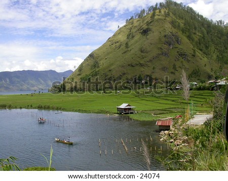 A Lake and boat with tropical mountainous