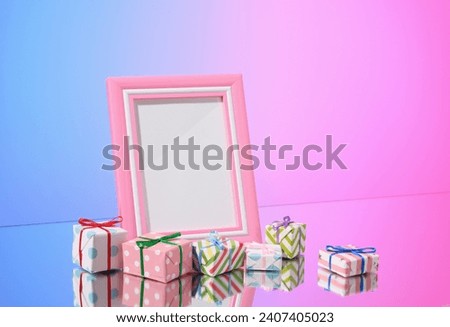 Pink creative photo frame and gifts. Birthday or party. Copy space for text.