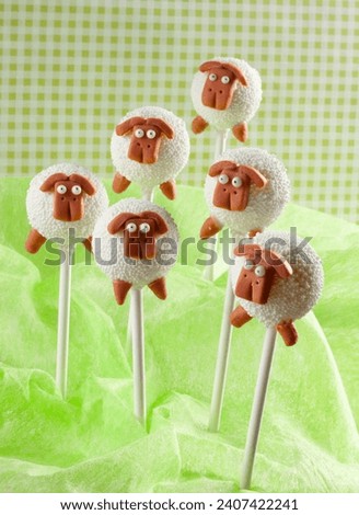 Group of sheep cake pops on green background