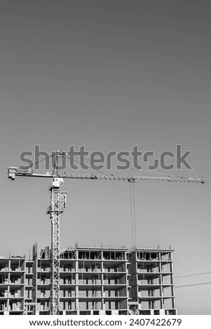 Big steel crane on construction site of residential building, photo consisting of large crane at construction site of residential building, high crane to construction site of residential building