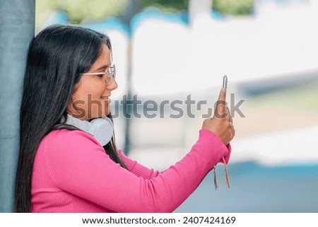 girl on the street looking at her mobile phone