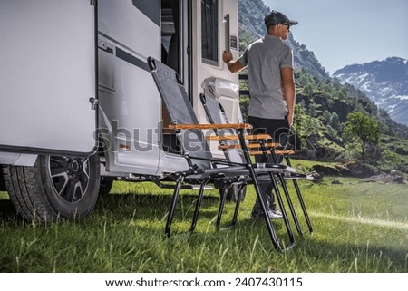 Vacation in a Recreational Vehicle. Caucasian RV Owner in Front of His Vehicle. Royalty-Free Stock Photo #2407430115