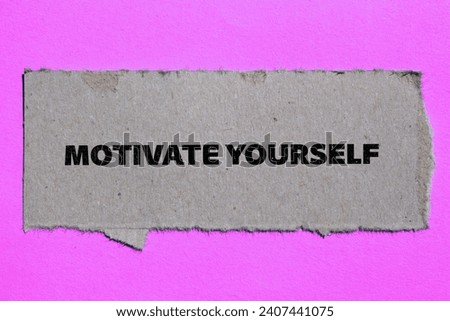 Motivate yourself lettering on ripped paper piece with pink background. Conceptual photo. Top view, copy space.