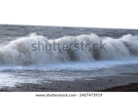 Waves crashing on to the beach at Brighton and Hove