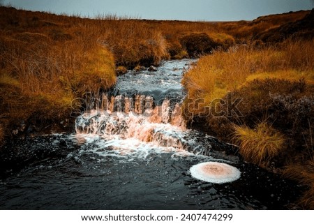 Small waterfall and froth, Maich Water, Mistylaw Muir , Renfrewshire, Scotland. Royalty-Free Stock Photo #2407474299