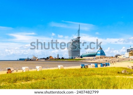 Cityscape and coast panorama of ATLANTIC Hotel Sail City lighthouse architecture ships boats dike and landscape of Bremerhaven in Germany.