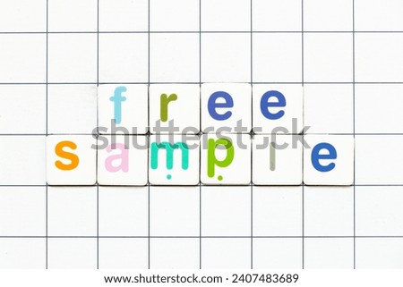 Colorful tile letter in word free sample on white grid background Royalty-Free Stock Photo #2407483689