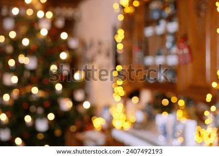 Blurred Section of Living Room Christmas Decoration with Christmas Tree and Lighted Cupboard