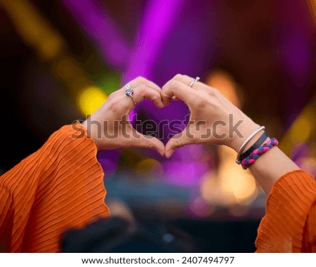 Close Up Of Person Making Heart Shaped Hand Gesture At Outdoor Summer Music Festival