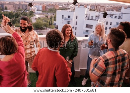 Group of friends celebrating and dancing on the terrace together and having fun. Concept: together.