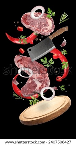Beef meat, different spices, cleaver knife and board falling on black background