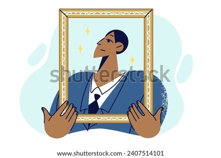 Proud man in business clothes holding golden portrait frame, for concept of narcissism and encouraging alter ego. Proud guy poses for honor board with pictures of company best employees Royalty-Free Stock Photo #2407514101