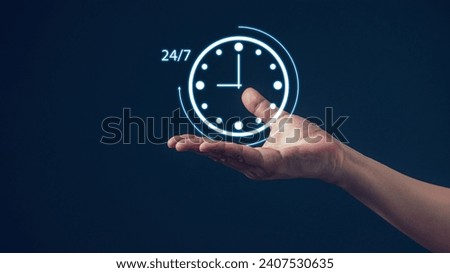 Nonstop service 24 hr concept. Man hand holding virtual 24-7 with clock on hand for worldwide nonstop and full-time available contact of service concept. Assistance customer services. Royalty-Free Stock Photo #2407530635