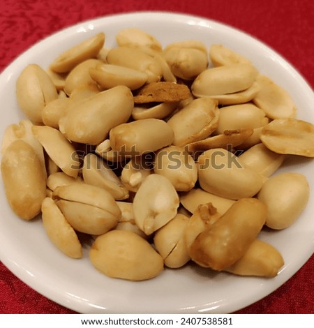 fried peanuts on a red tablecloth... lucky peanuts... peanuts for good fortune... 