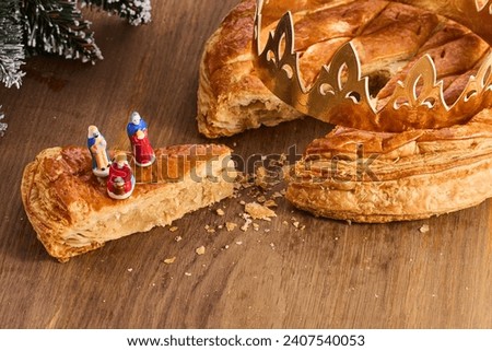 Galette des rois on wooden table.Traditional Epiphany cake in France Royalty-Free Stock Photo #2407540053