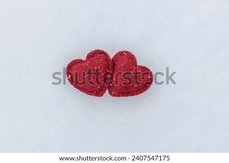 Two Red hearts on snow in winter. Happy valentines day celebration. Heart love concept.