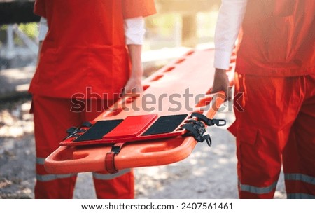 Close up of Emergency Rescue Team Holding Transfer Stretcher to Help Patient in Emergency Situation. Critical Medical Assistance and Rescue Services in Action Royalty-Free Stock Photo #2407561461