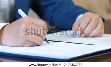 Business man signing a contract.