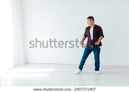 Male coach dancing in bright studio white