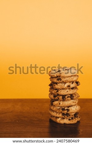 Inviting breakfast scene: cookies and milk on a rustic table with an orange backdrop. Perfect for marketing.