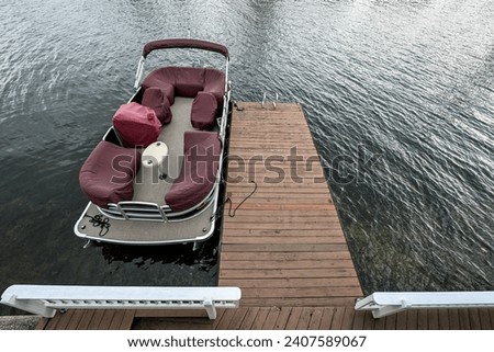 pontoon boat in the lake at the dock Royalty-Free Stock Photo #2407589067