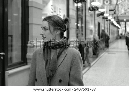 Portrait of a young woman walking down the shopping street