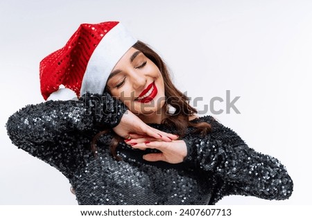 A Woman Wearing a Santa Hat Posing for a Picture. A woman wearing a santa hat posing for a picture