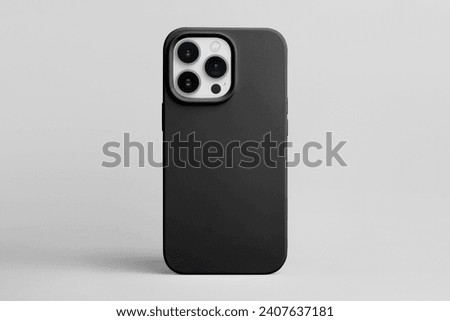 iPhone 15 Pro in black phone case back view isolated on grey background, phone case mock up for 14 Pro max Royalty-Free Stock Photo #2407637181
