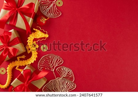 Honoring customs with thoughtful Chinese New Year gifts. Top view flat lay of gold dragon, gift boxes, ginkgo biloba, lucky coins, lanterns on red background with ad panel