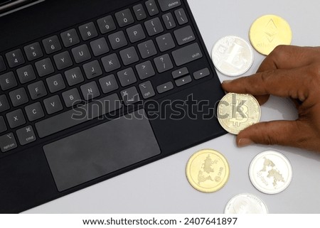 hand holding bitcoin on computer keyboard background isolated white background.