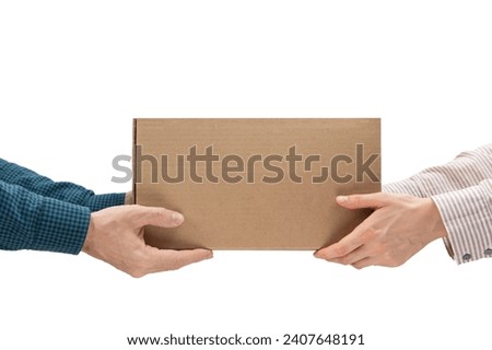 Male hands giving a package, female hands receiving a package. Purchase delivery concept Royalty-Free Stock Photo #2407648191